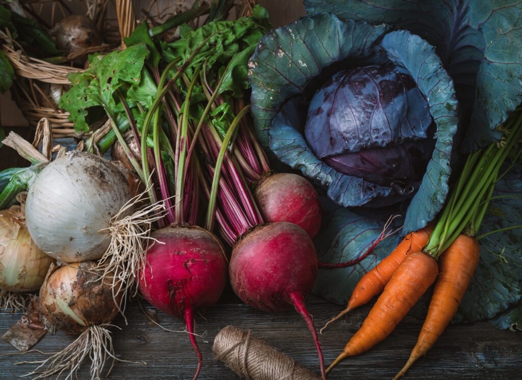 A colourful selection of fresh vegetables on a wooden table